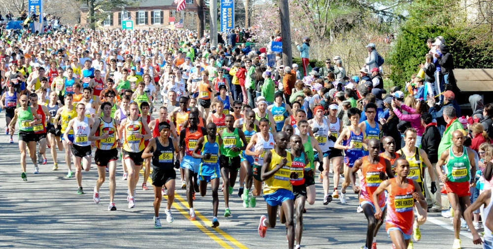 Runners competing in B.A.A. Half Marathon along Boston streets