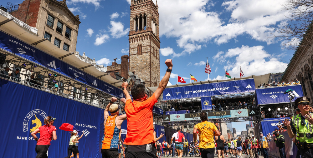 Runners participating in Boston Marathon with crowd cheering